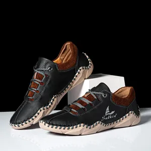 Detail view of handmade stitching and black pebbled leather on men's casual shoes