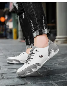 Detail of white and grey paneling on casual men's sneakers with black ram head logo