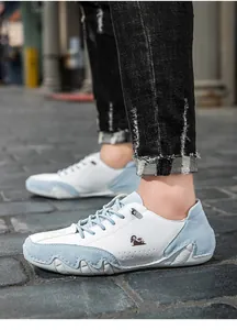Detailed view of low-top casual shoes with white leather and light blue suede paneling