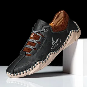Detail shot of stitched leather and corduroy casual shoes with rubber sole and logo