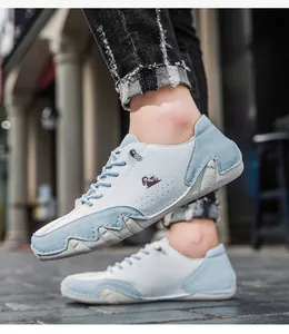 Outdoor shot of men's casual sneakers in white and blue featuring animal logo and lace-up