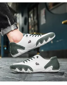 Detail view of leather casual shoes with dark green suede panels and unique wavy sole edges