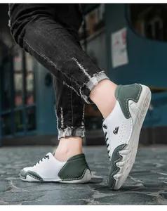 Detail showing white and green leather stitching with wave-patterned anti-slip sole