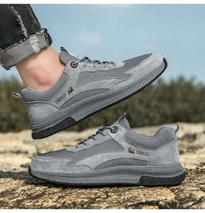 Detail of gray leather mesh sneakers with non-slip rubber soles and bird embroidery