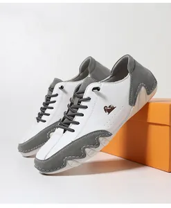 Detailed side view of white and gray leather low-top casual shoes with wavy rubber soles