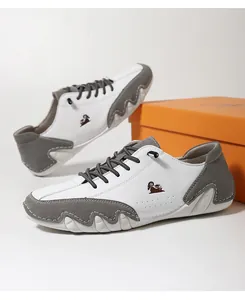 Detail view of men's casual outdoor sneakers with ram logo and wavy textured white sole