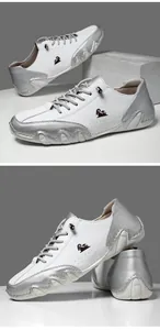Detail shot of men's white leather casual shoe with silver metallic trim and sheep logo