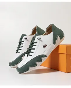 Detailed view of low-top casual sneaker with white and green color-blocking and non-slip sole