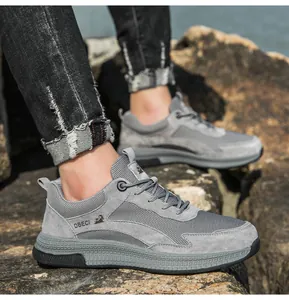 Close-up of grey breathable mesh and leather casual sneaker on a male model outdoors