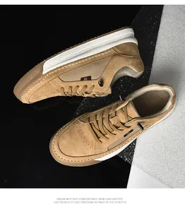 Close-up of brown suede sneakers with striped side ribbon and white chunky sole