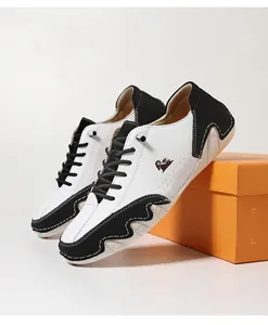 Detail of black and white contrast leather casual shoes with wave sole and goat logo