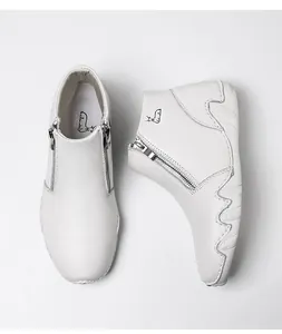 Detail view of white leather ankle boots with dual metal zippers and unique wave sole