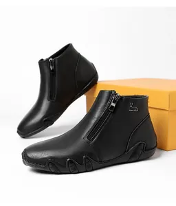 Macro detail of black leather ankle boots with side zipper and silver reindeer logo