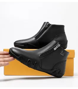 Detail of premium black leather boots with side zipper and wave anti-slip sole pattern