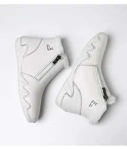 Detail of white leather boots featuring plush faux fur lining and side zipper closure