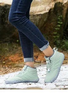 Detail of warm green outdoor snow boots showing fleece lining and anti-slip rubber soles