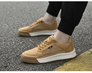 Outdoor side view of khaki suede leather casual sneakers with thick white rubber soles