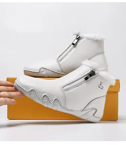 Detail of white leather winter boots featuring faux fur trim and a side zipper closure