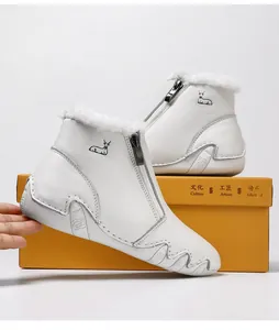 Detail view of white leather winter boots featuring faux fur lining and side zipper