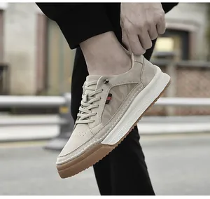 Close-up of beige suede leather sneakers with non-slip thick sole and red stripe detail