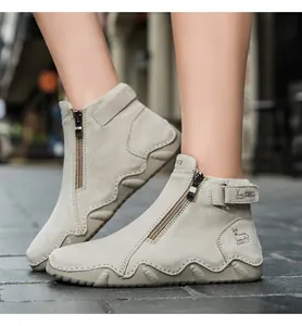 Detail of light beige suede women's boots featuring side zipper and non-slip wavy sole