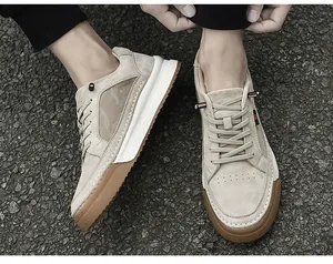 Outdoor shot of beige suede sneakers with breathable mesh and thick composite soles