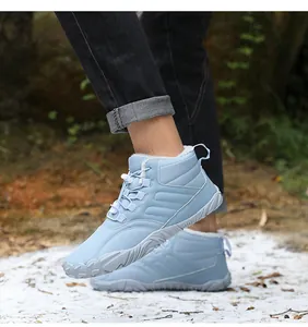 Detail of light blue winter snow boots with warm faux fur lining and anti-slip rubber sole