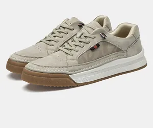 Macro detail of gray suede leather stitching and thick rubber sole on casual sneakers