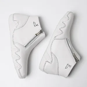 White leather high-top boots with silver side zipper and black animal logo detail