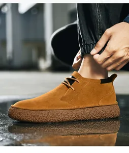 Side view of men's brown suede mid-top boots featuring non-slip thick rubber soles