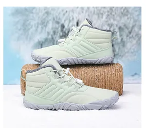 Close-up of mint green winter boots featuring warm fleece lining and anti-slip rubber soles
