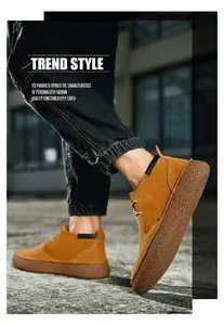 Detail of men's mid-top suede casual boots featuring thick rubber lug soles and tan leather
