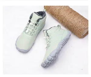 Detail of mint green winter boots with plush faux fur lining and anti-slip rubber sole