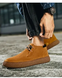 Detail of ginger suede leather low-top boots with textured anti-slip rubber thick sole
