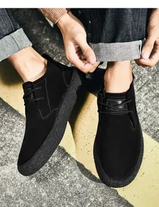 Close-up of black matte suede casual boots for men with textured gum thick soles