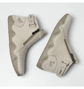 Detail view of leather high-top boots featuring side zipper and ankle strap ornament