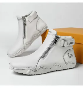 Detail of white leather boots with side zipper and durable non-slip rubber soles