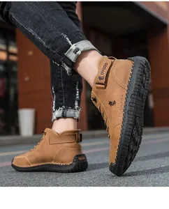 Detail of retro brown leather boots featuring rugged hand-stitching and rubber grip soles