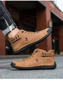 Detailed view of hand-stitched seams and fox logo on brown high-top casual leather boots