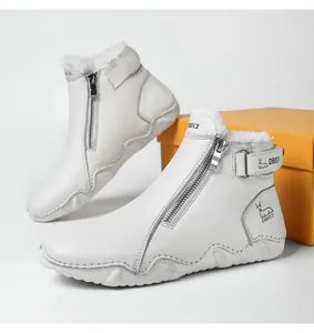 Detail of warm white leather boots featuring a side zipper and thick faux fur lining