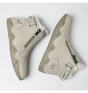 Detail showing plush faux wool lining and premium beige suede texture on winter boots