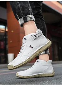 Detail of high-top men's shoes with rugged hand-stitched soles and velcro ankle straps
