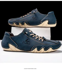Detail of navy nubuck boat shoe showing hand-stitched seams and a white wavy sole