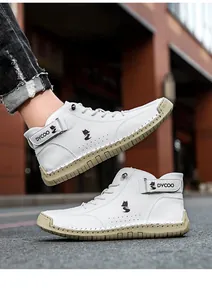 Detail of white leather high-top shoes with stitched rubber soles and fox logo