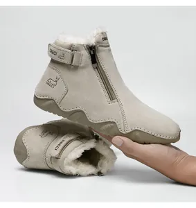 Detailed close-up of warm faux fur lining and side zipper on leather winter boots