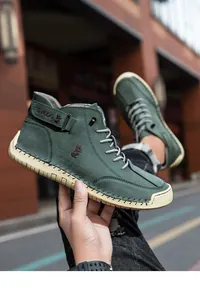 Detail of hand-held dark green high-top boot showing stitched rubber sole and fox logo