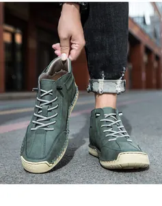 Close-up of green men's high-top shoes with contrast hand-stitching and rubber sole