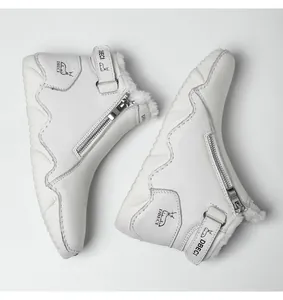Detail of white leather boots showing thick faux shearling lining and side zipper closure