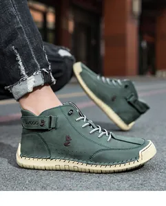 Detail of high-top casual men's boots with retro stitching and a velcro ankle strap