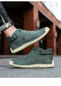 Close-up of green high-top men's shoes with stitching detail and thick rubber sole